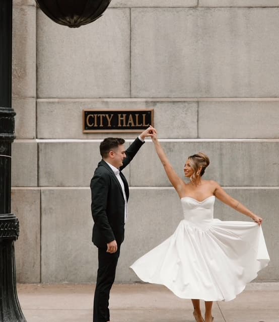 Newlyweds dancing outside City Hall