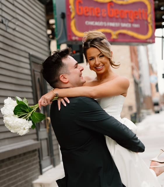 Newlyweds embracing outside Gene & Georgetti in Chicago