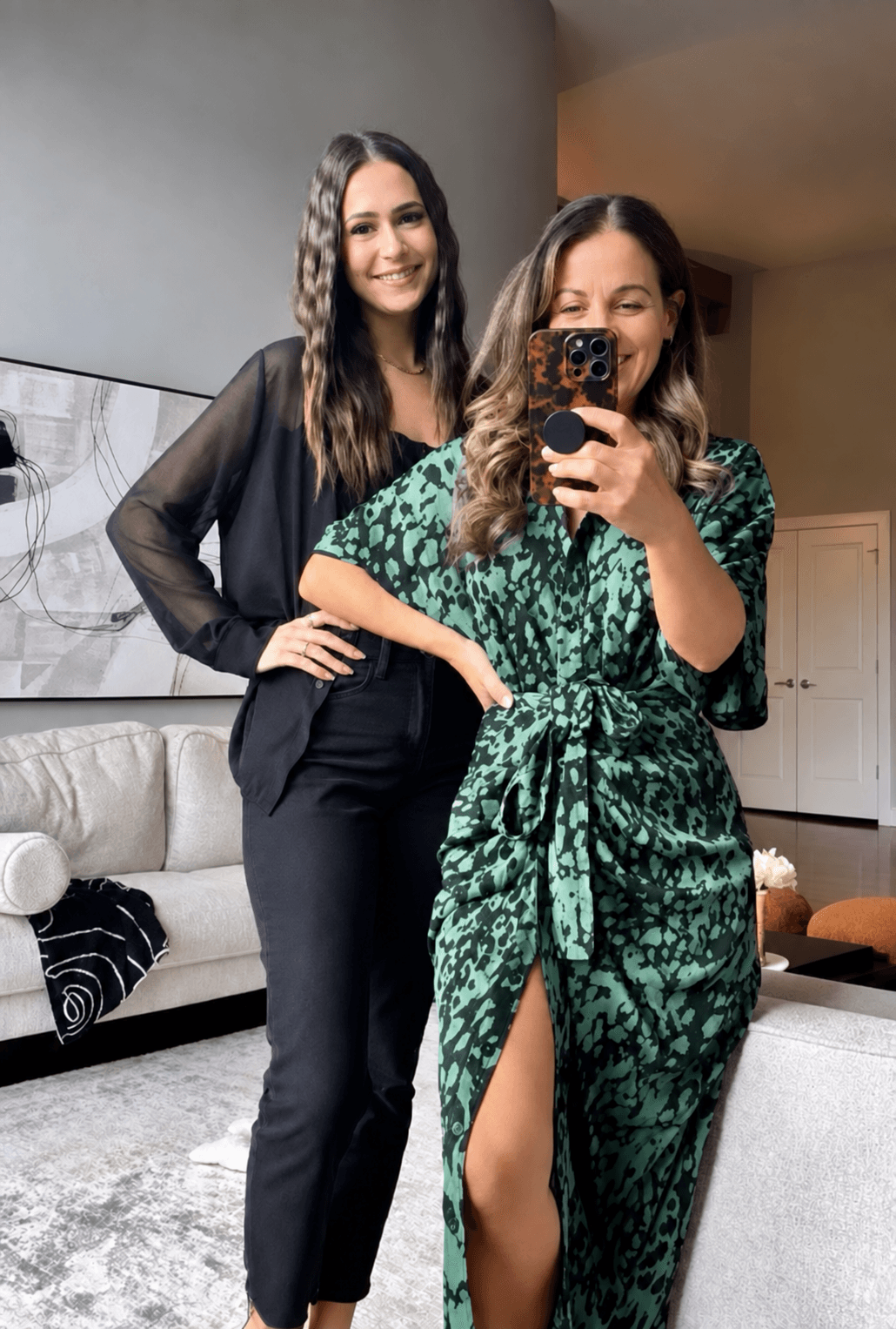 Jenn and Steph smiling together in a mirror