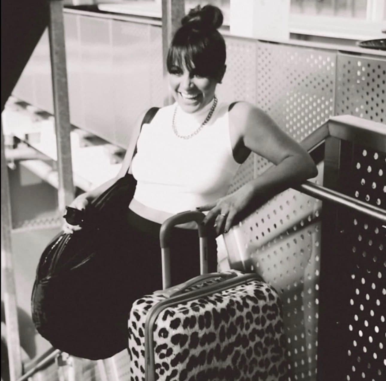 Jenn with her mobile spray tan bags and leopard-print suitcase