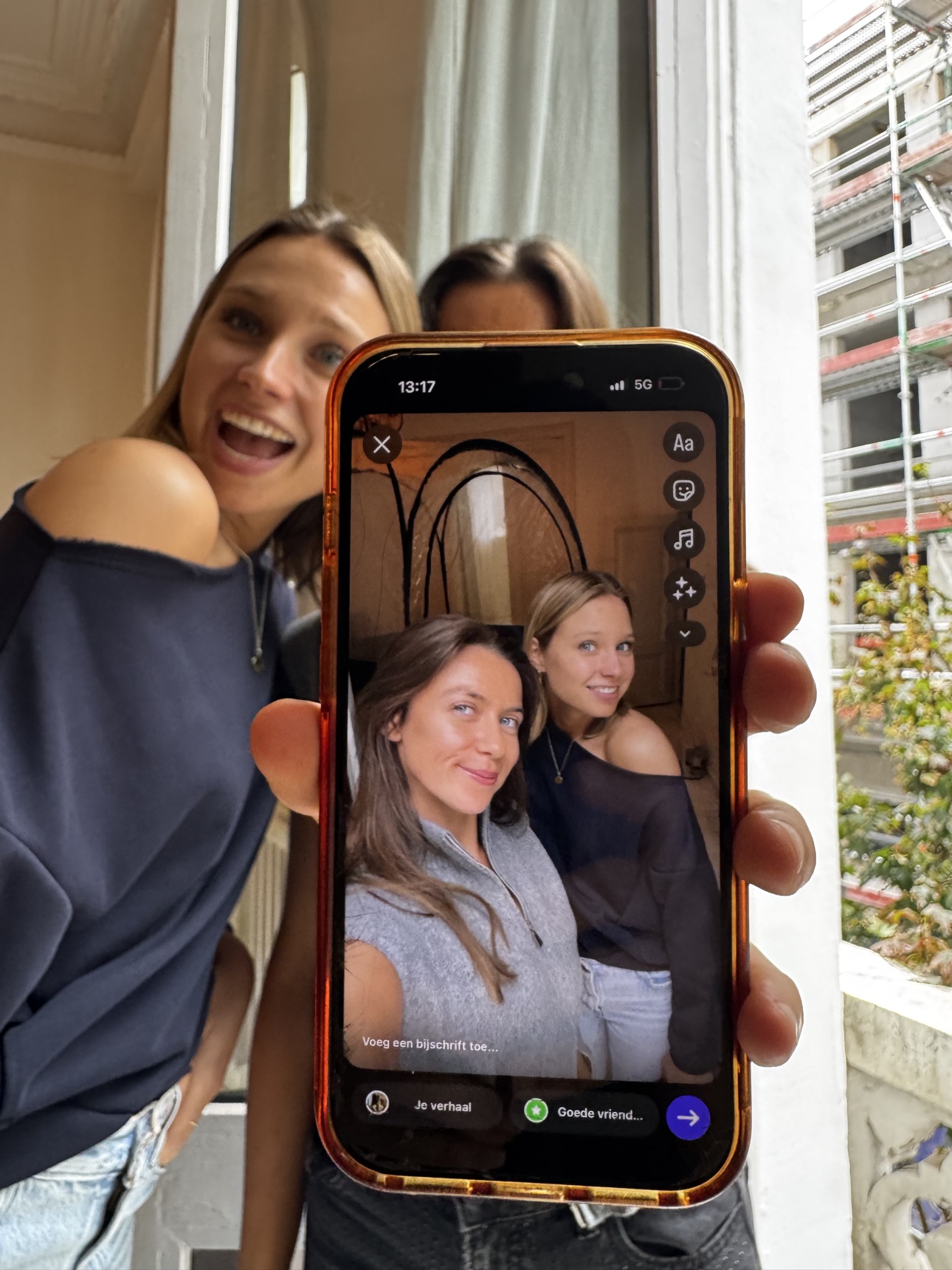 A phone sharing a social moment from the spray tan training