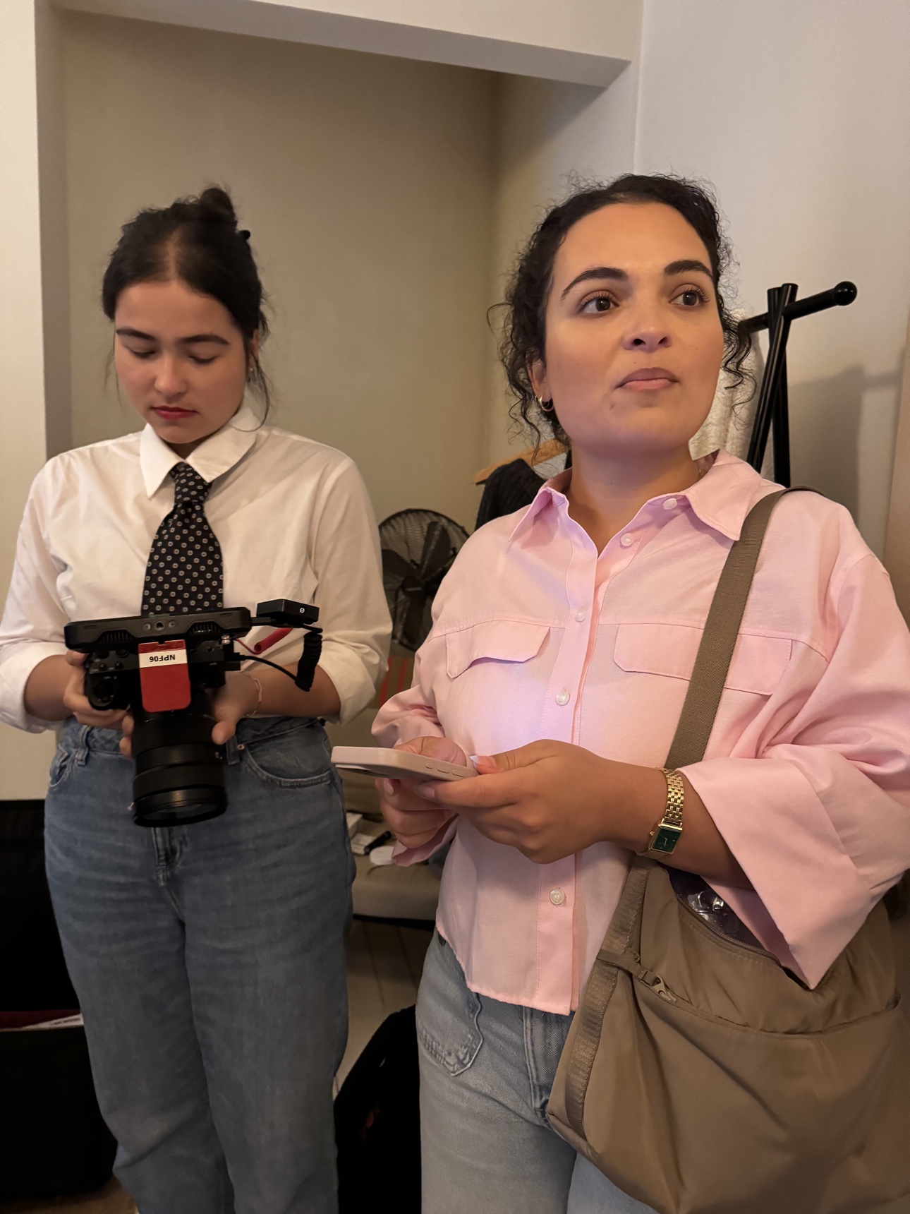 Two members of the content crew preparing a camera during the workshop