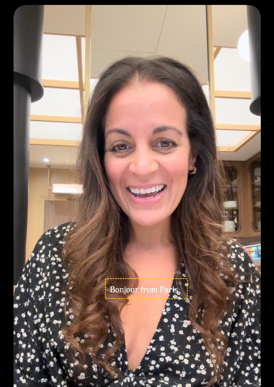 Jenn smiling in Paris in a black floral dress