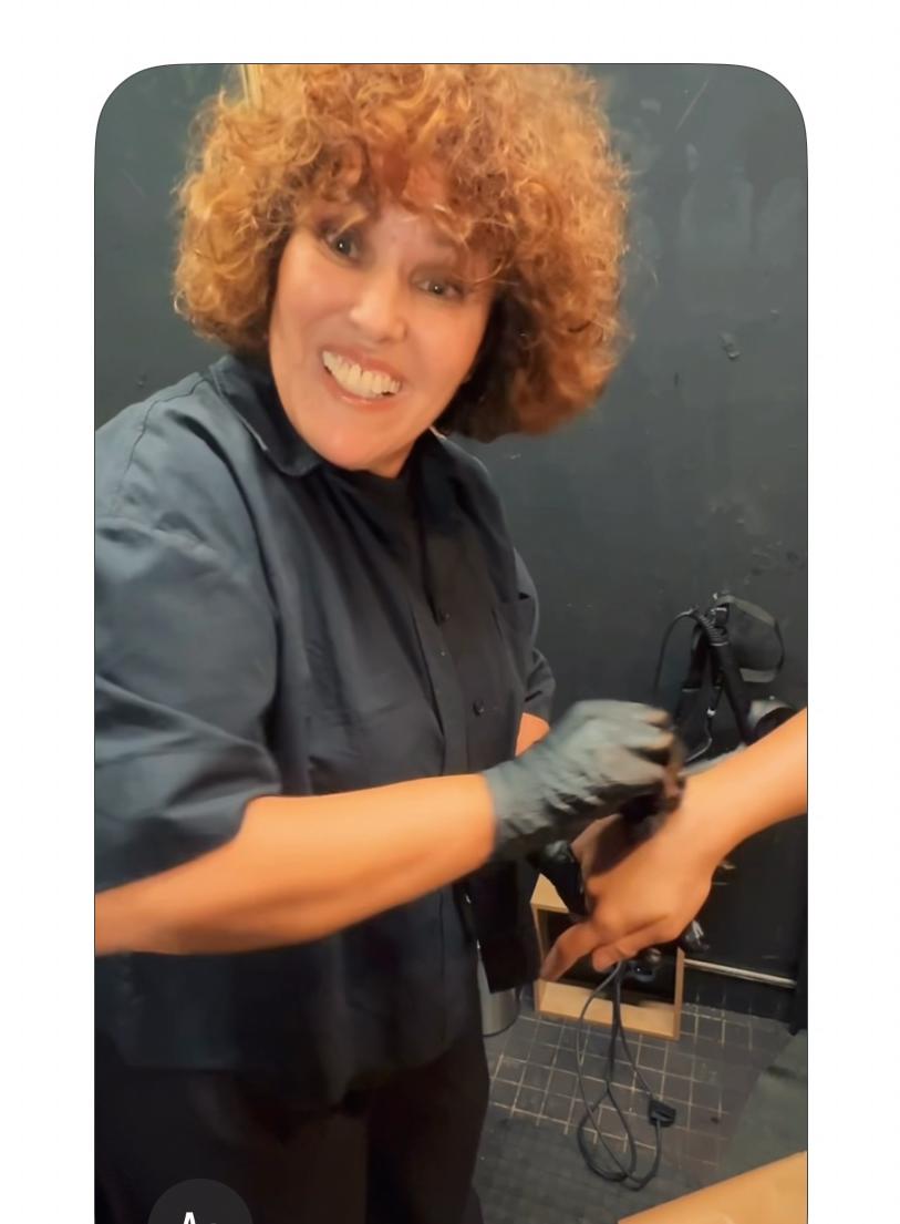 A smiling artist working during a hands-on beauty session