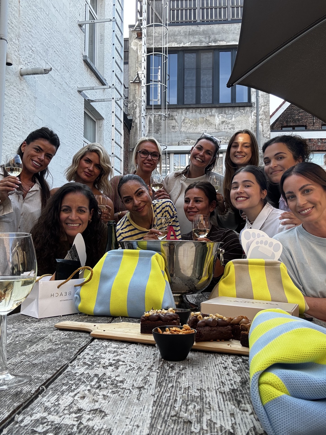 The tour group gathered around an outdoor table with wine and gifts